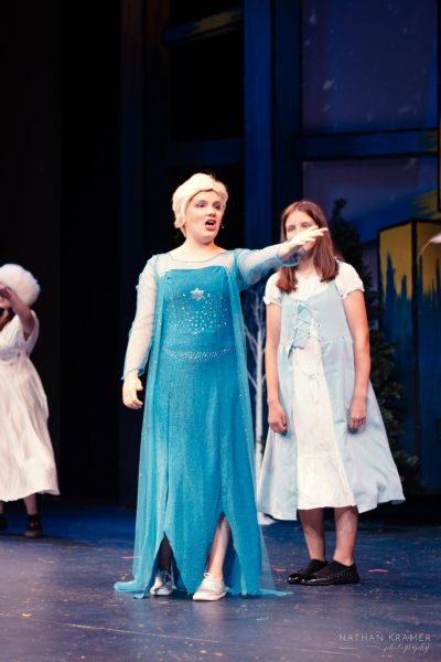 Singing Let it Go to the crowd, Free State alumnus Elizabeth Heinz performs as Elsa in the Penguin Project’s production of Frozen Jr. 