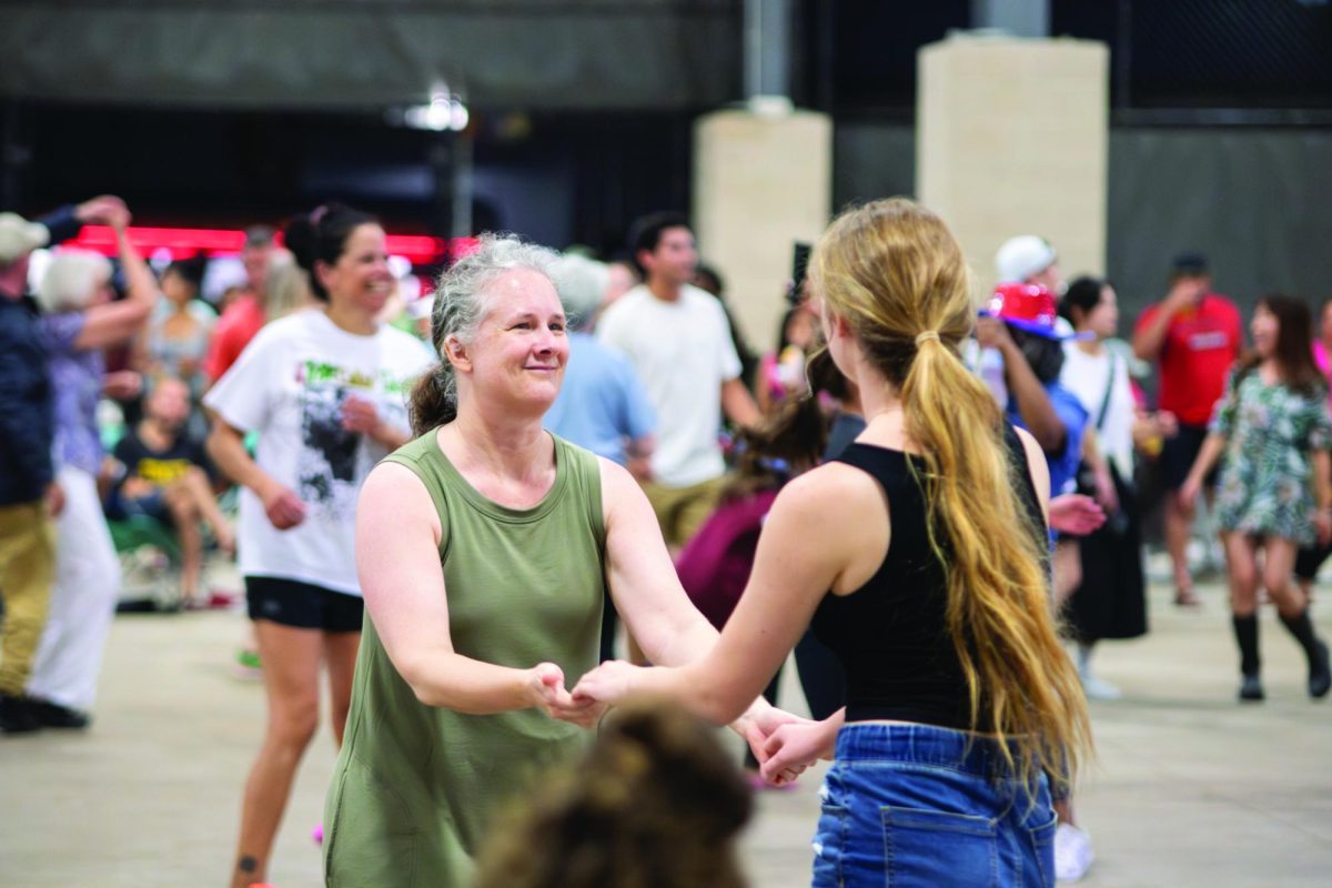 Dancing together, Lawrence community members enjoy live music. Throughout the day, seven bands performed at Summerfest.