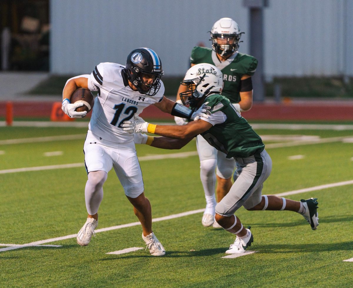 Senior Noah Rupp grabs the opponent for a tackle