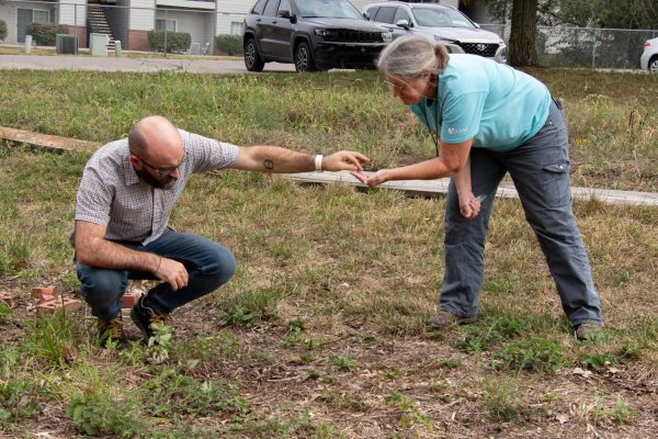 Surveying the damage, science teachers Julie Schwarting and Sam Gleeson take the Green Team to look at their once full garden that was mowed over by the district.