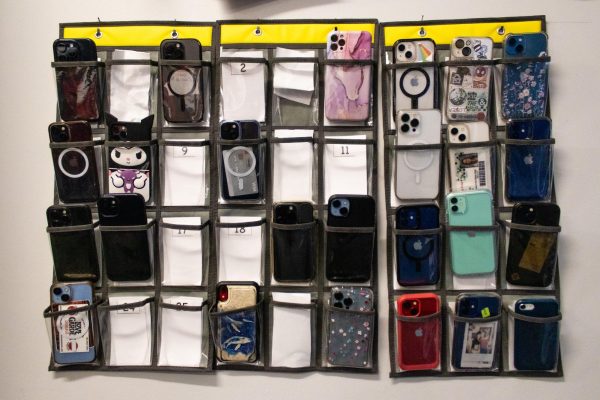  Math teacher Lawrence Baker advocates for keeping students' phones put away through his numbered cell phone caddy. “I really think this helps some of the students that just reach for their phone out of habit. Asking the students to put their phones in the caddy still requires them to follow the rules and there will always be students who won’t do that, so this doesn’t help them and I end up still having to police those students. That’s why I want to see a total ban,” Baker said.