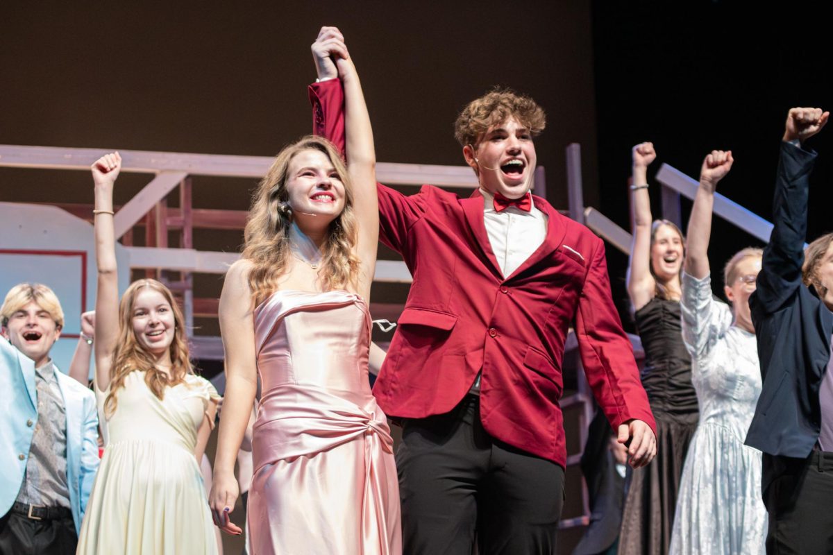 Singing together, senior Vivi Riffel and junior Colby Stutler perform in the closing number, "Footloose." 