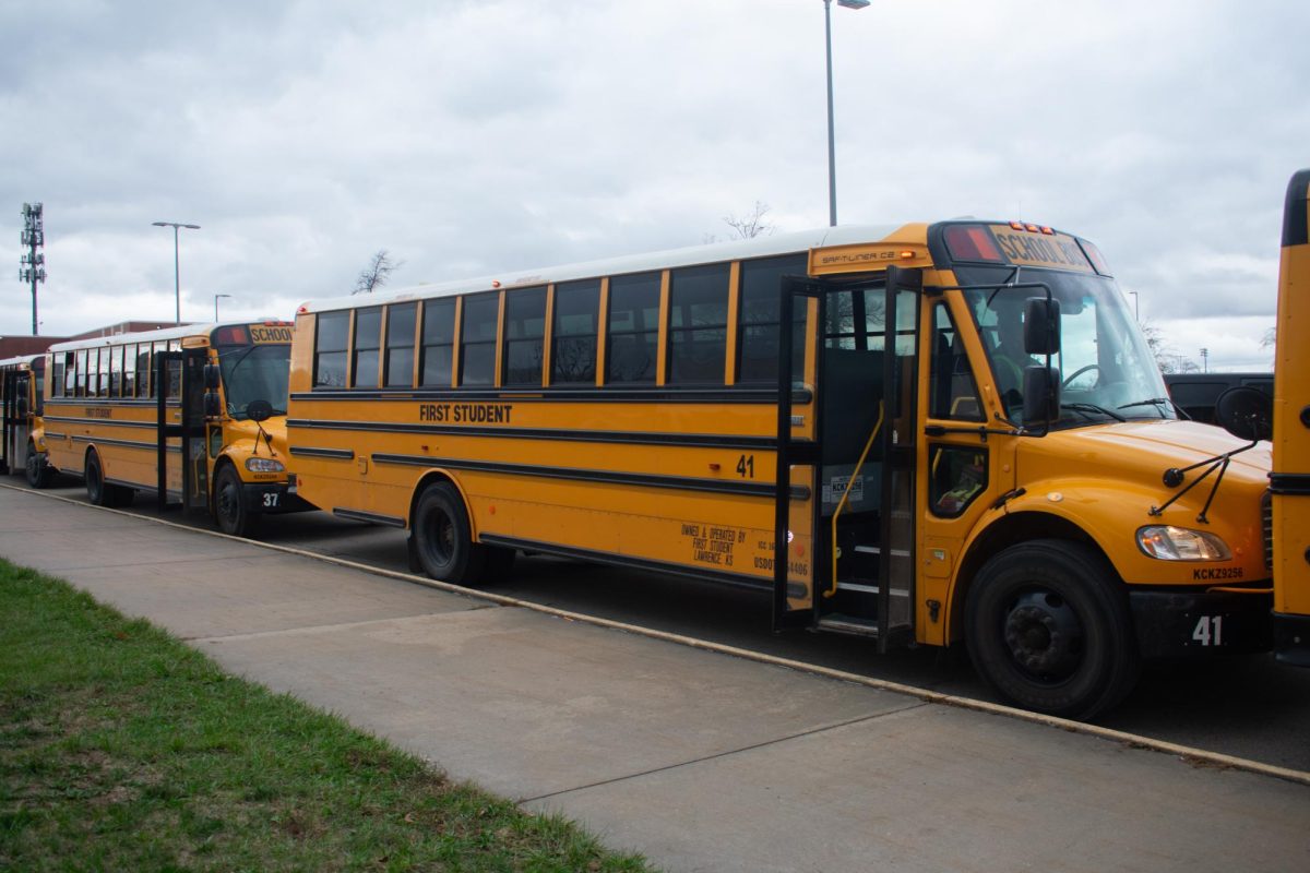 Waiting for students, a bus is parked outside of Free State.