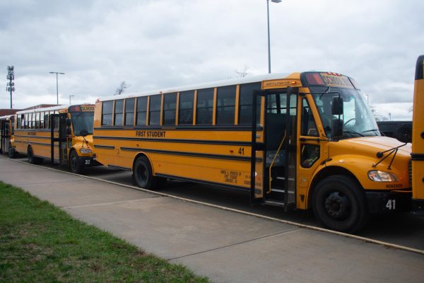 Waiting for students, a bus is parked outside of Free State.