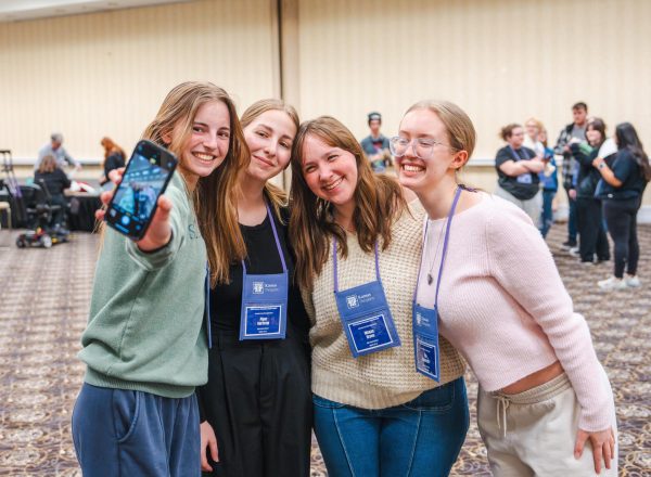 Smiling, juniors Landry Koester, Piper Northrop, Megan Green, and Ebi Hegeman pose for a selfie.