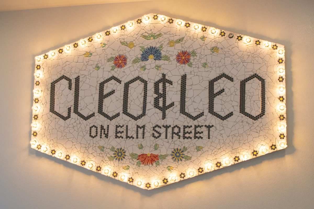 Hanging on the wall, the mosaic sign for Cleo And Leo's bakery is on display inside of the restaurant.