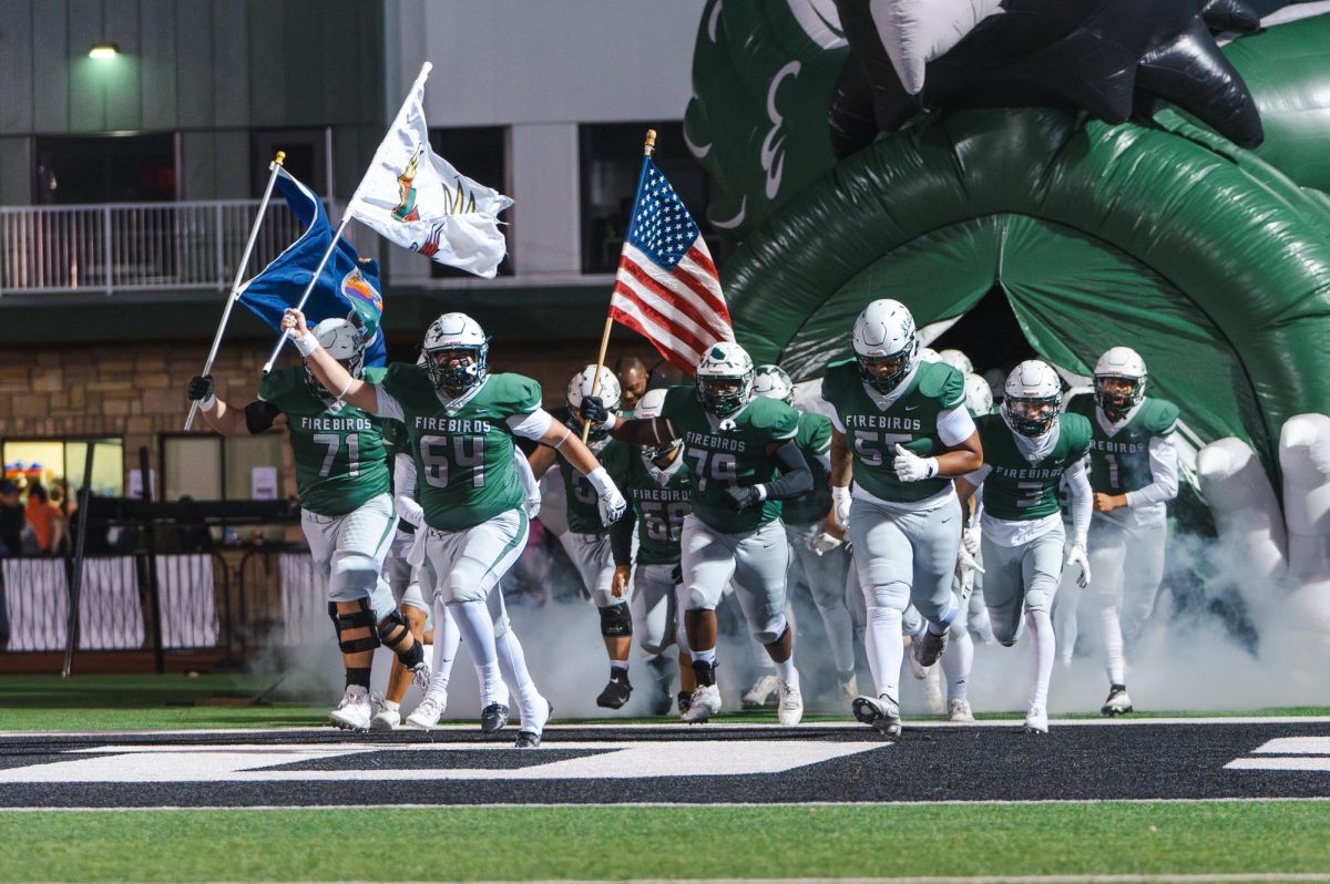 The Free State Football team rushes onto the filed prior kickoff of the City Showdown 