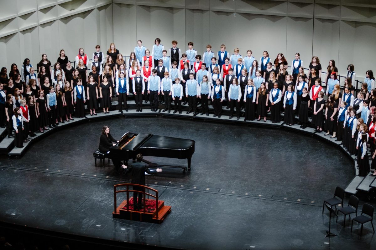 Under the direction of Washburn University choral director Dr. Lawrence Abernathy, the combined middle school choirs sing SONG. 