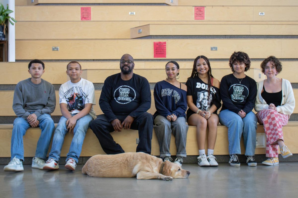 Posing, members of CanWeTalk sit on the learning stairs.