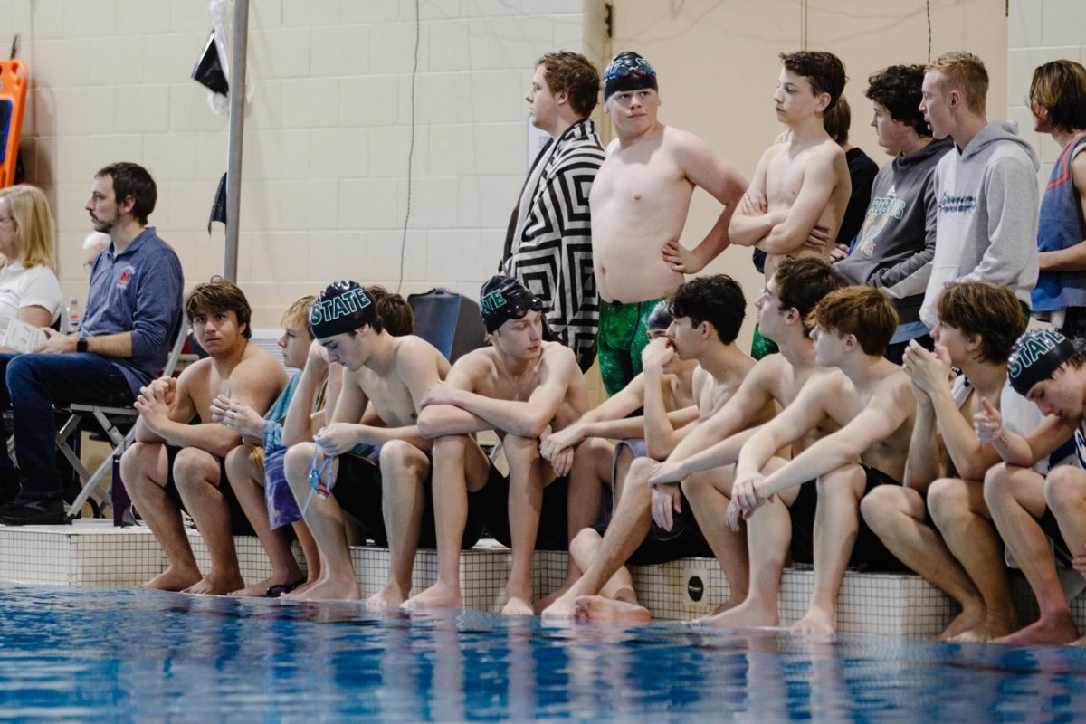 Waiting on the sidelines, the Boys Swim and Dive team prepares to swim.